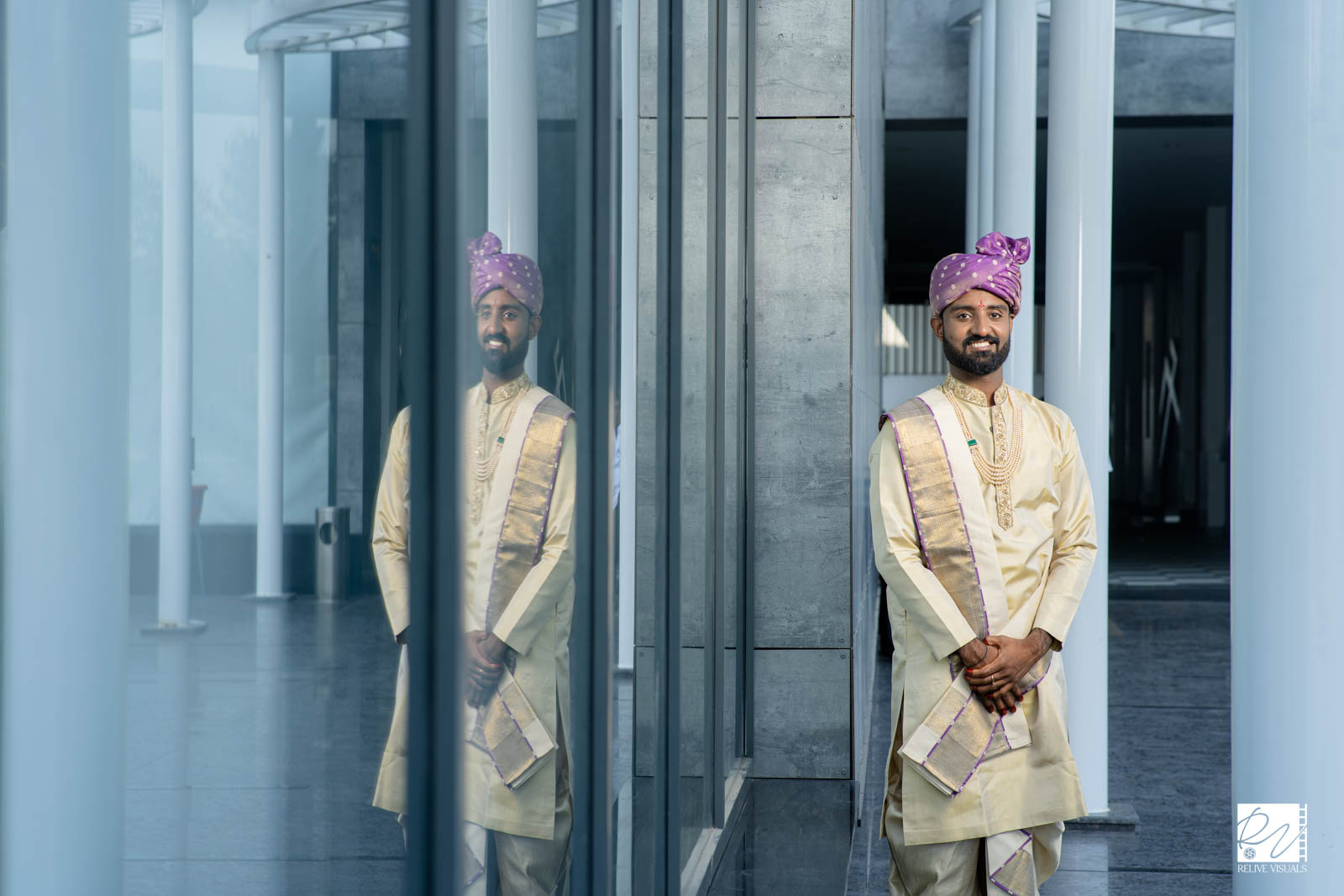 A groom in traditional muhurtham attire, standing with a calm and proud expression.