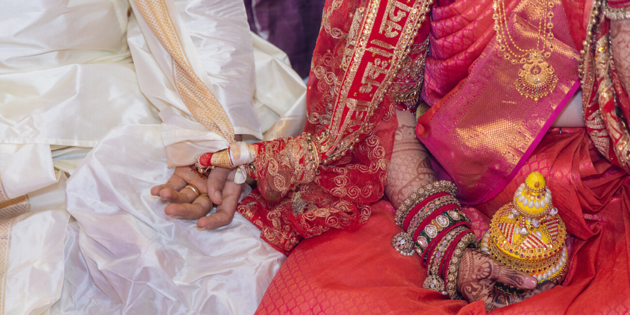 bride styled in the traditional Kongu Mudi, with her hair beautifully coiled and adorned with jasmine flowers, exuding timeless elegance.
