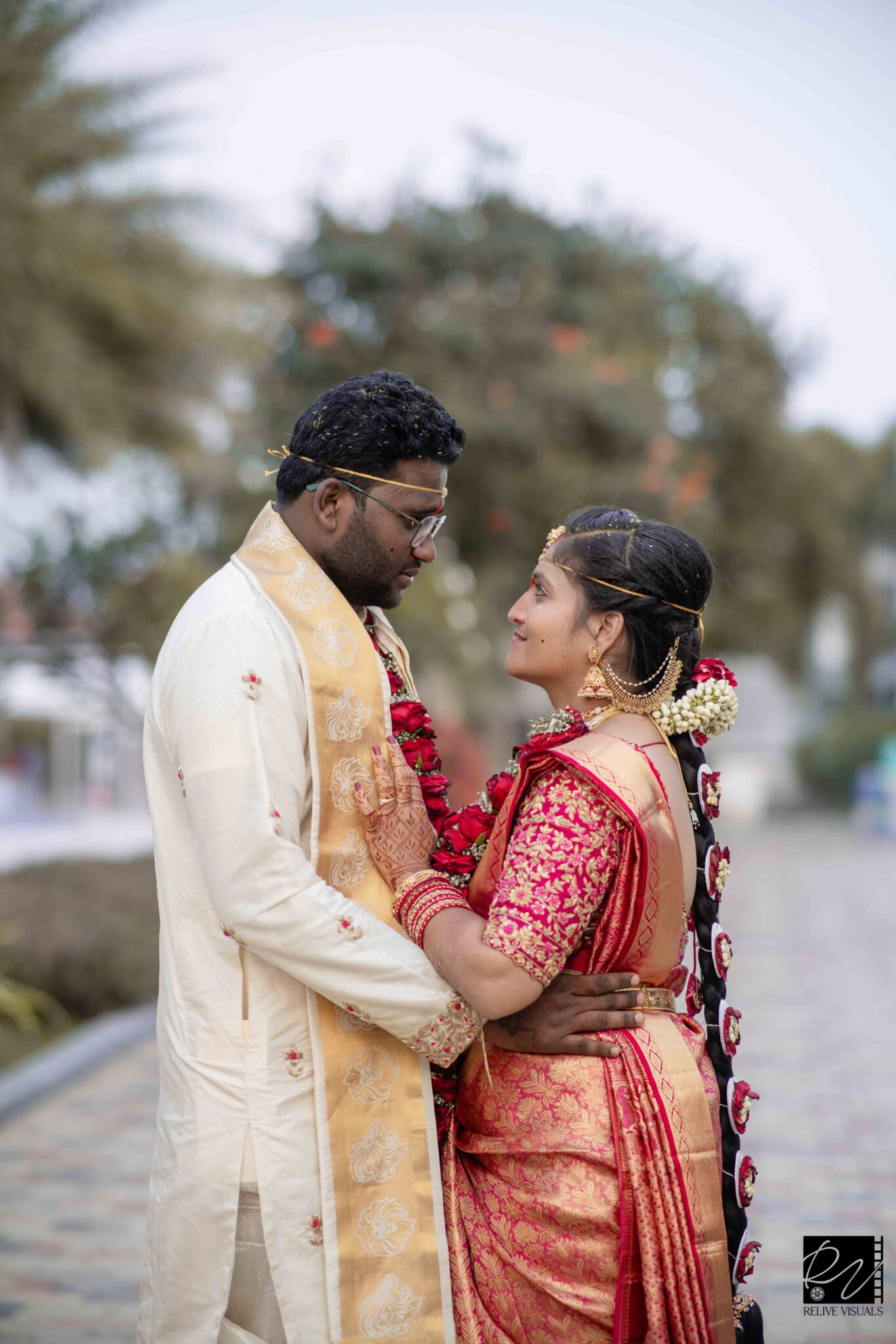 "Telugu bride and groom facing each other and sharing an intimate moment during a post-wedding photoshoot"