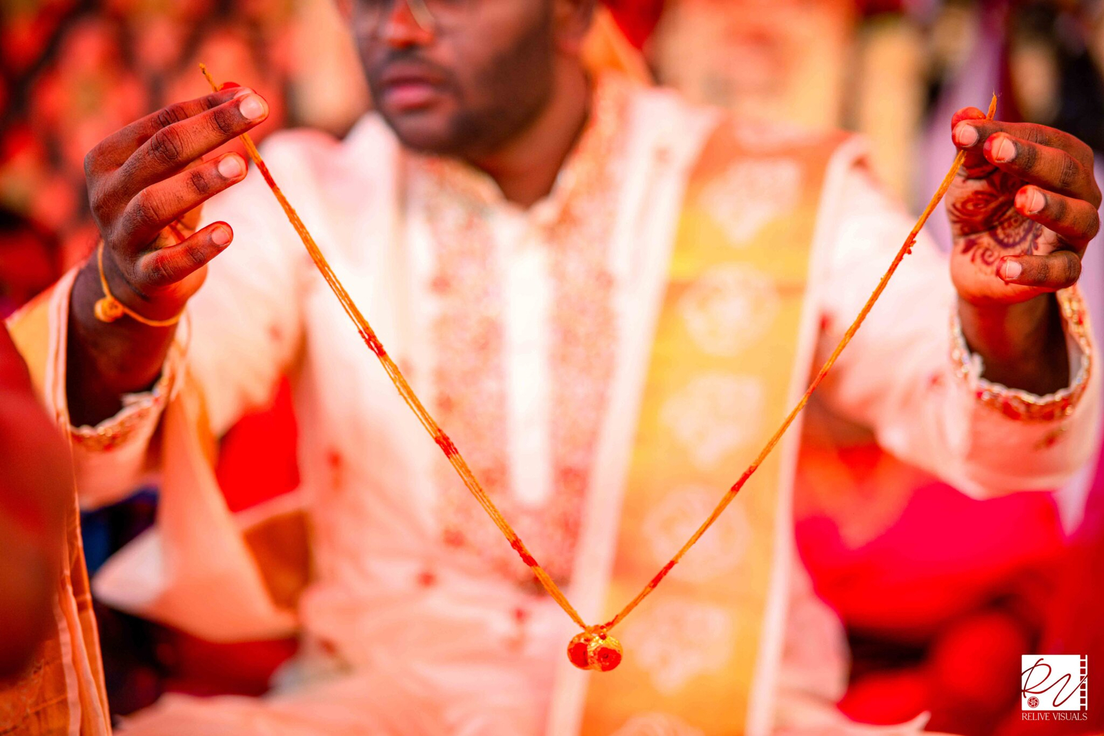 "Telugu groom holding the Thali (Mangalsutra) and showing it to the wedding guests during the ceremony"