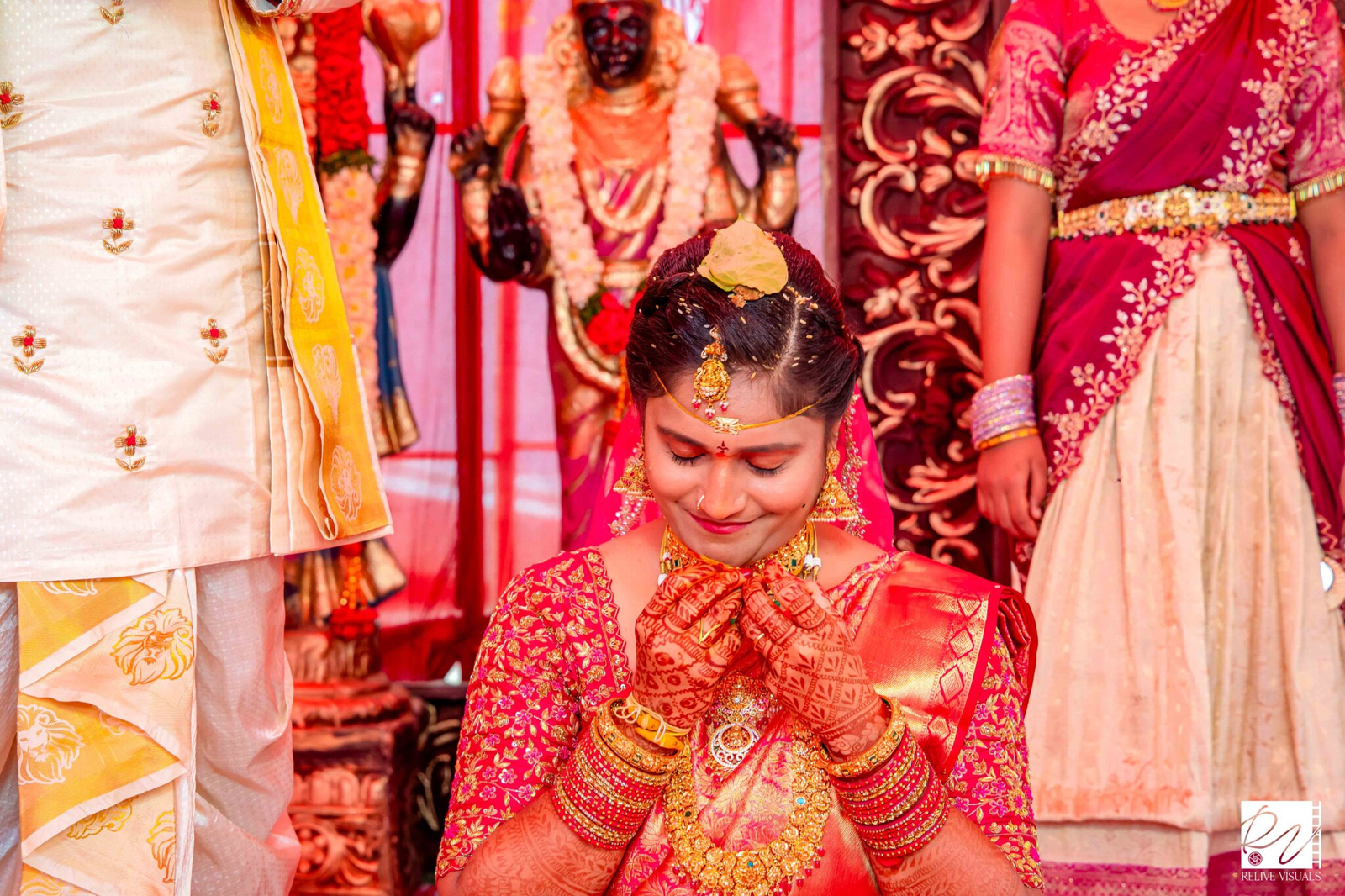 "Telugu bride holding the Thali (Mangalsutra) close to her eyes as a sign of respect and prayer during the wedding ceremony"