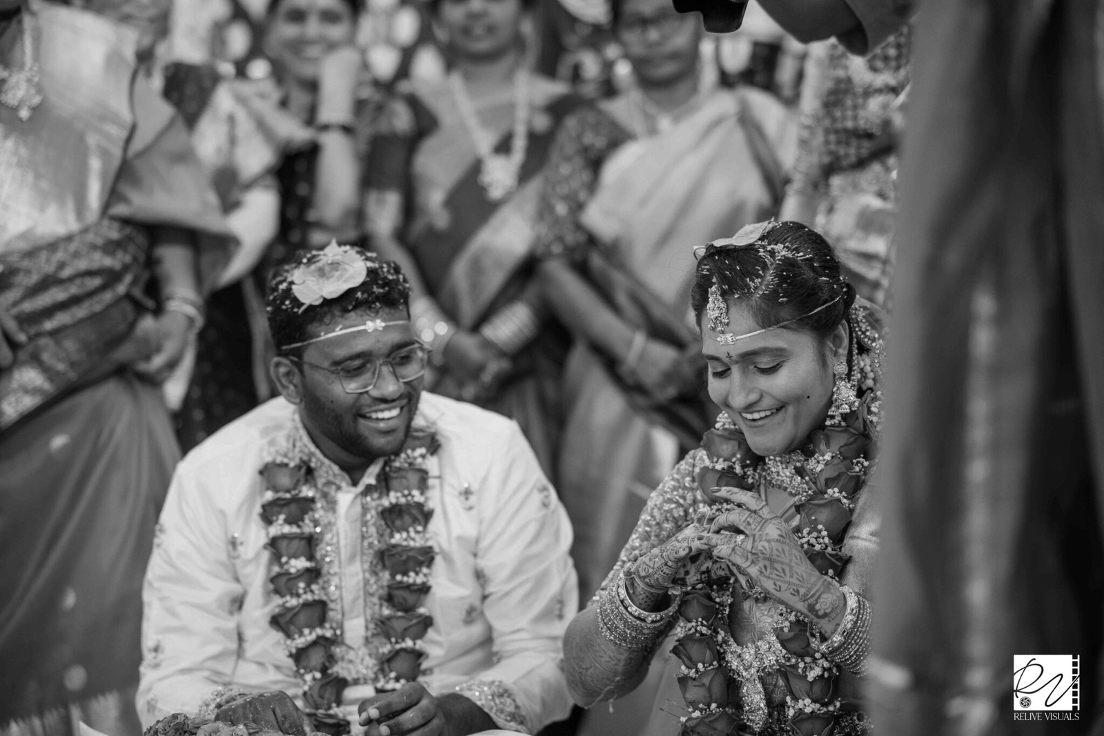 "Telugu bride smiles triumphantly after winning the ring game, as the groom lovingly gazes at her during the wedding ritual"