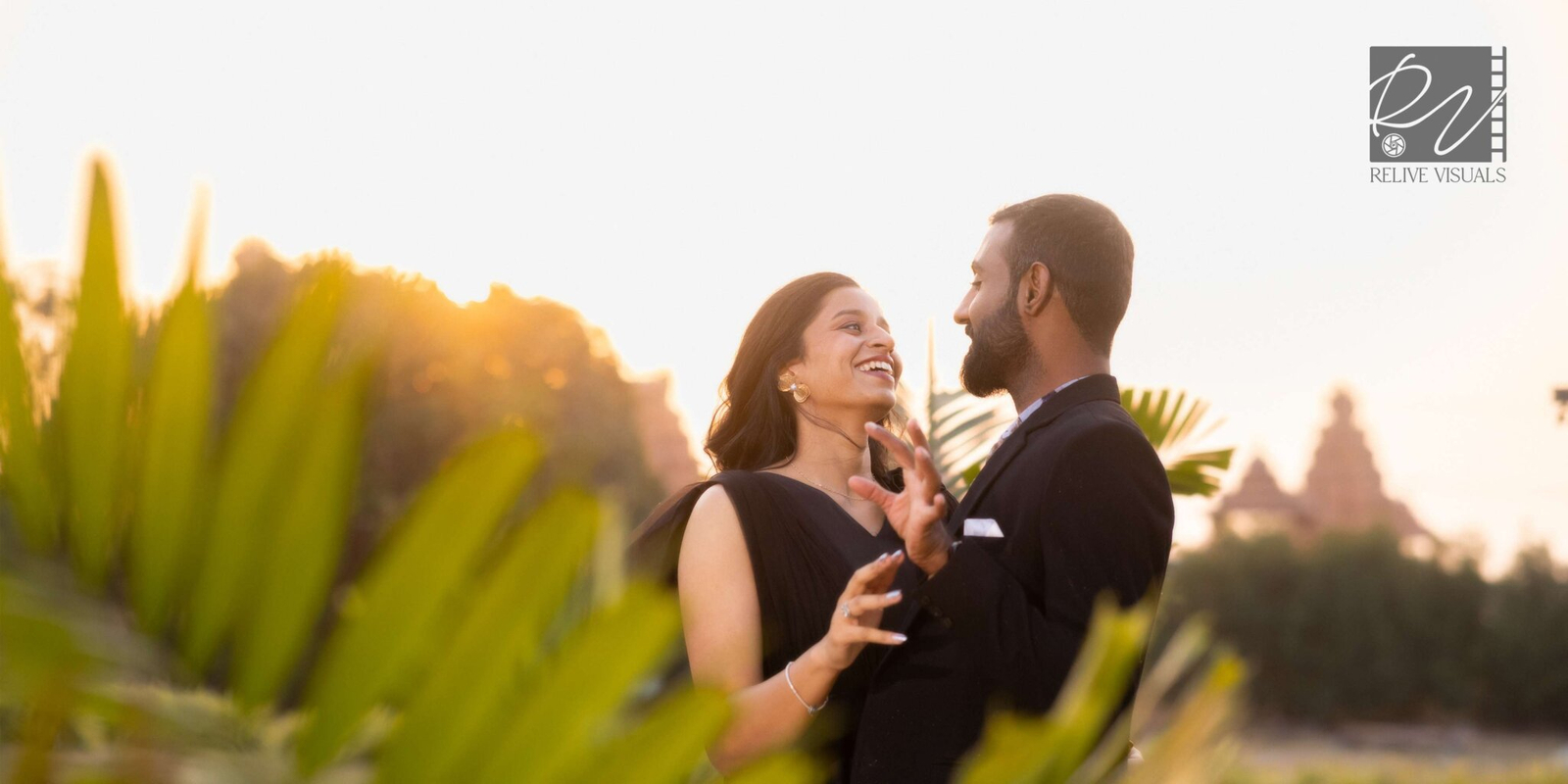 Bride and groom gazing into each other’s eyes, with the golden sunrise casting a warm glow behind them in a wide romantic frame.