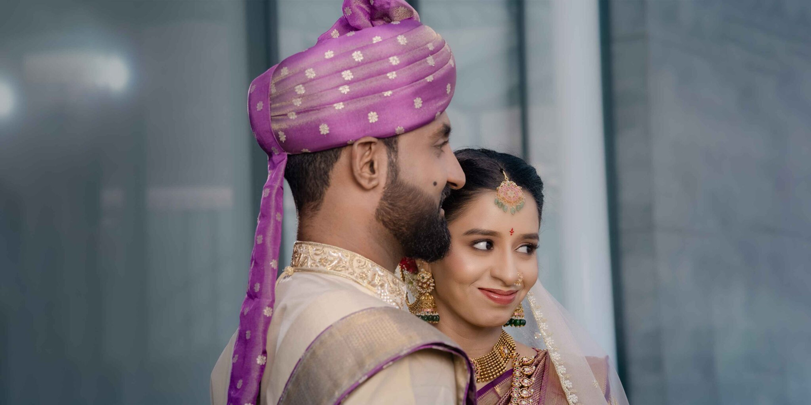 Close-up of the bride and groom within a wide portrait frame, capturing their intimate expressions against a scenic backdrop.
